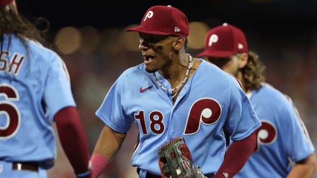 Oct 12, 2023; Philadelphia, Pennsylvania, USA; Philadelphia Phillies center fielder Johan Rojas (18) celebrates after catching the fly ball of Atlanta Braves designated hitter Marcell Ozuna (20) to end the top of the seventh inning during game four of the NLDS for the 2023 MLB playoffs at Citizens Bank Park. Mandatory Credit: Bill Streicher-USA TODAY Sports